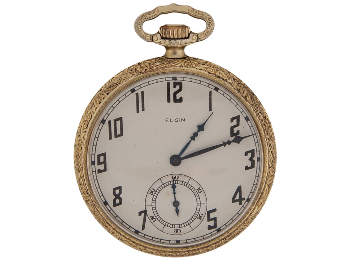 A gold pocket watch with a white dial and small seconds subdial on a plain background.
